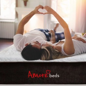 Couple Making A Heart On Amore Mattress